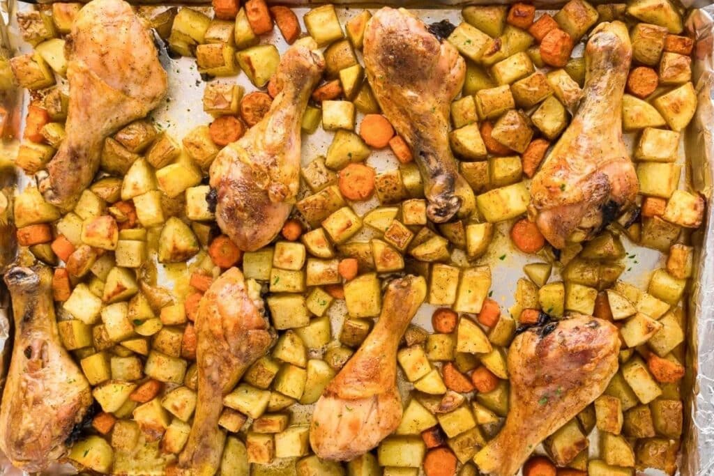 Oven baked chicken drumsticks on a sheet pan.