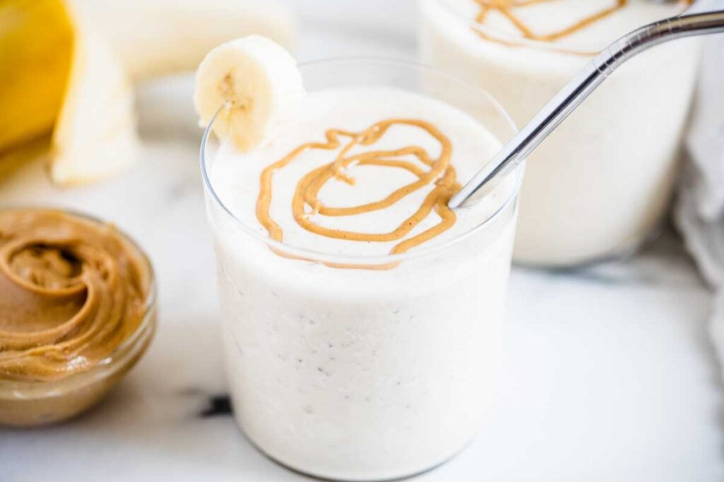 Peanut butter banana smoothie in a glass.