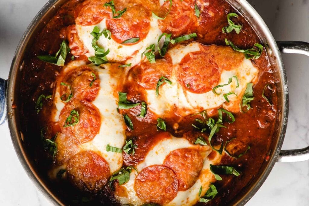 Pizza chicken in a skillet.
