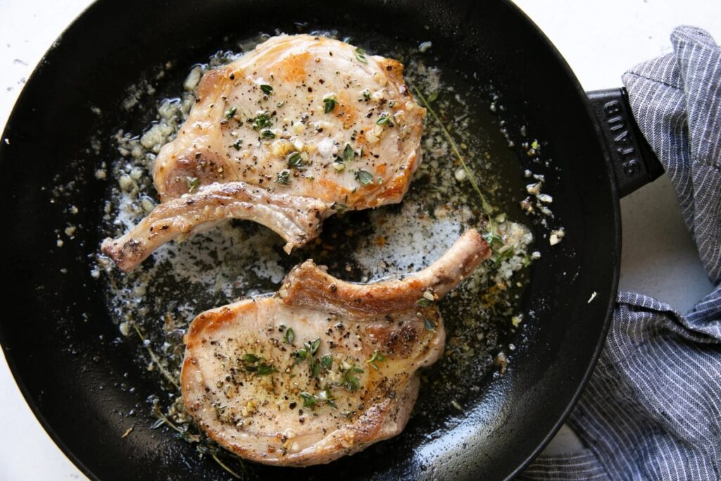 Pork chop recipe in a skillet.