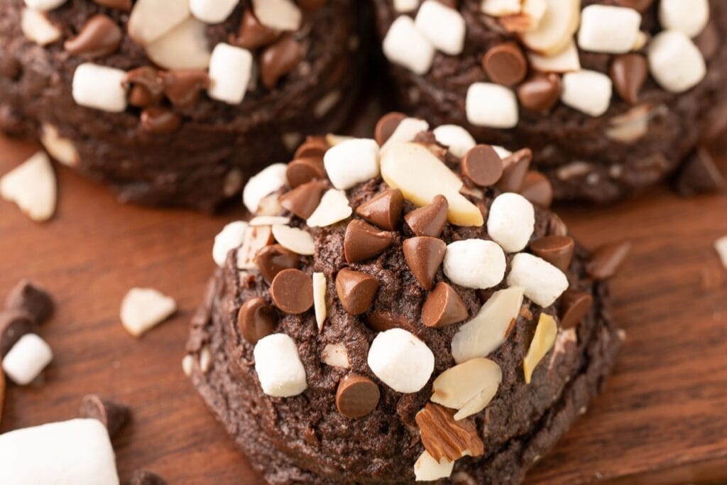 Rocky Road pudding cookies arranged on a wooden board.