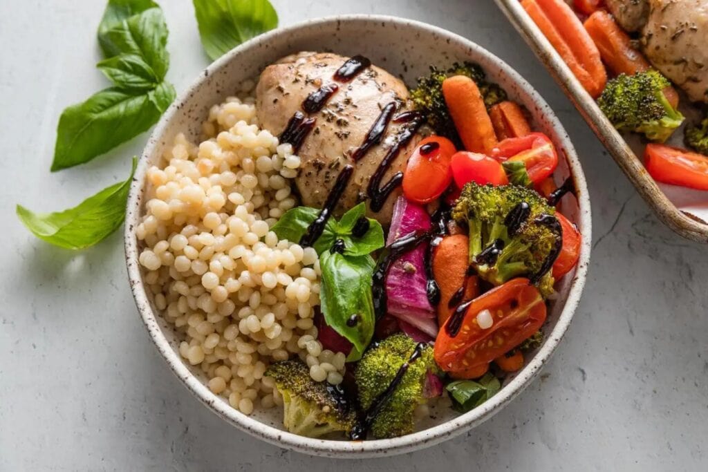 Sheet pan balsamic chicken and veggies in a bowl.