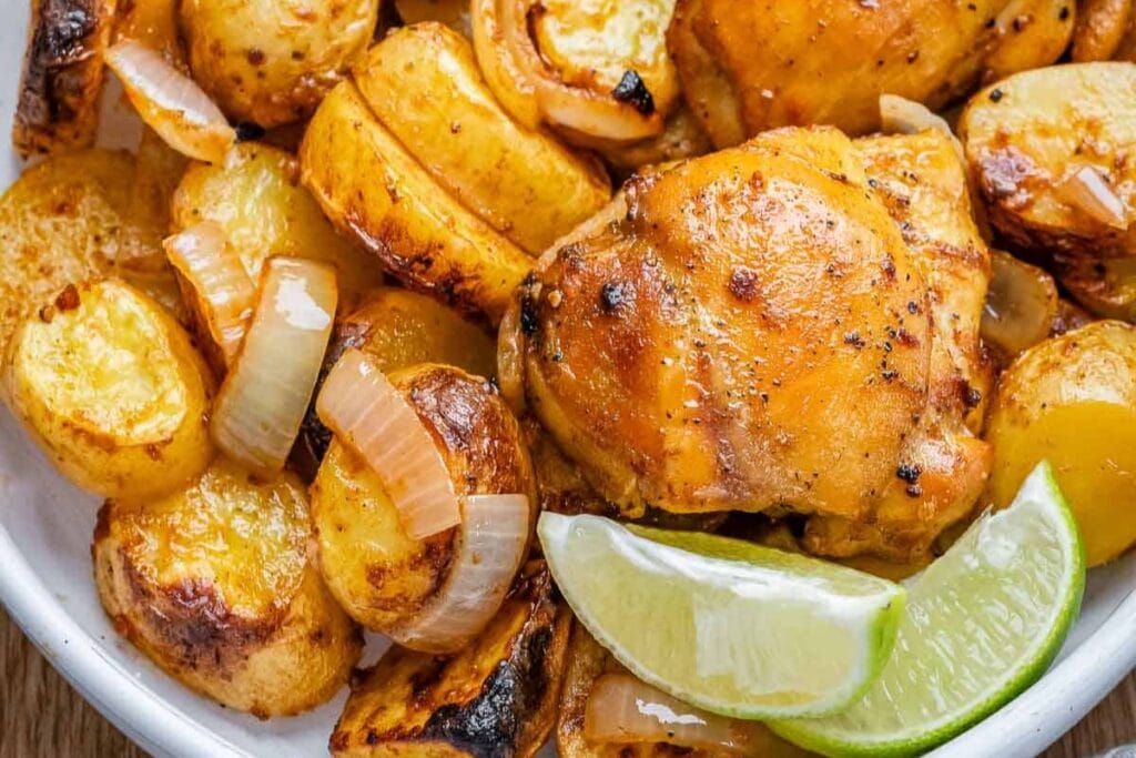 Sheet pan chicken and potatoes on a plate.