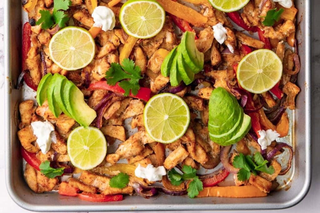 Baked chicken fajitas on a sheet pan.