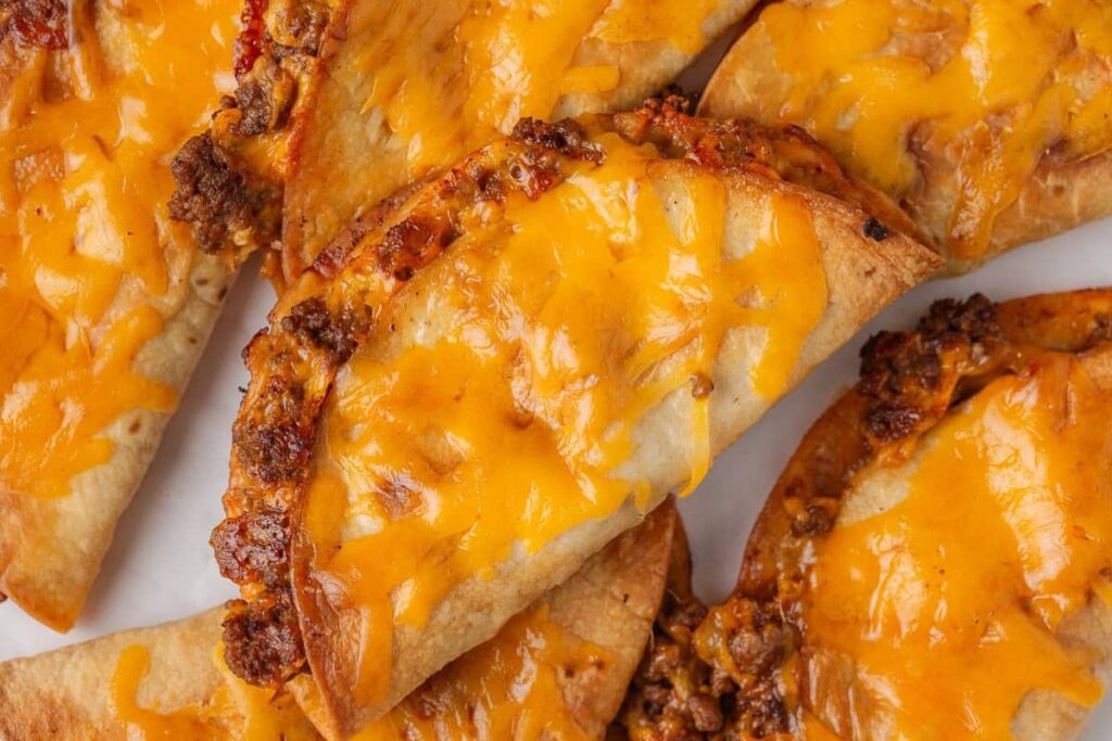 Sheet pan tacos with melted cheese.