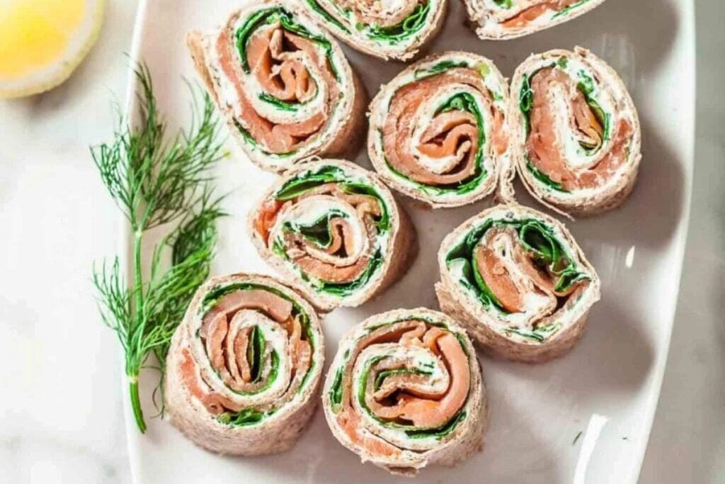 Smoked salmon roll ups on a plate.