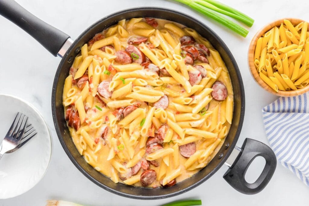 Smoked sausage pasta in a skillet.