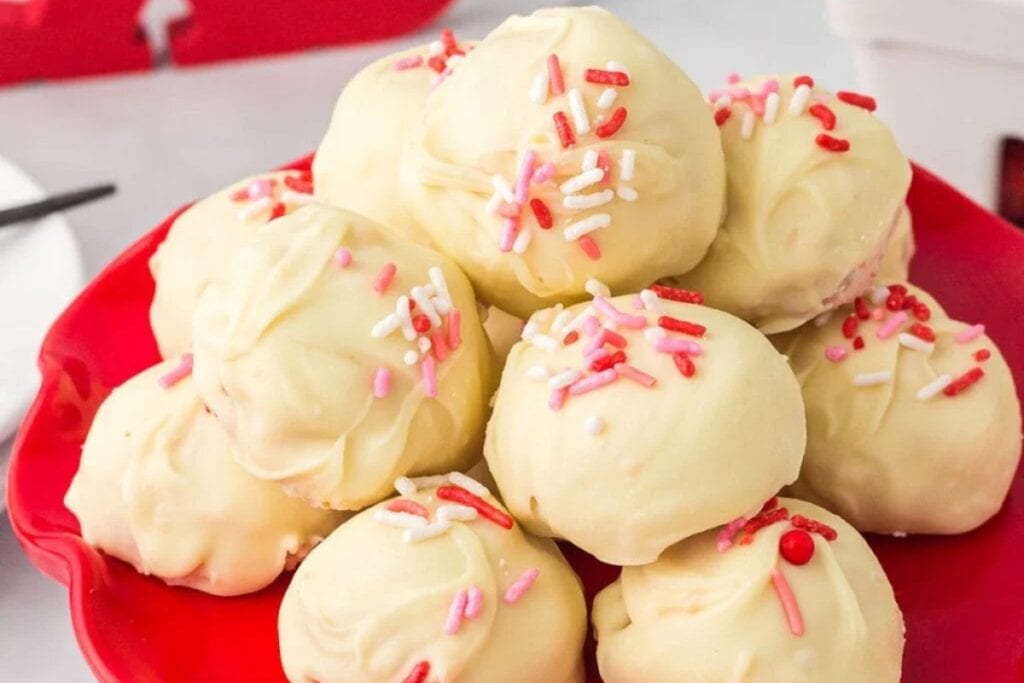 Strawberry shortcake truffles on a plate.
