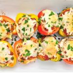 Stuffed bell peppers arranged in a baking dish.
