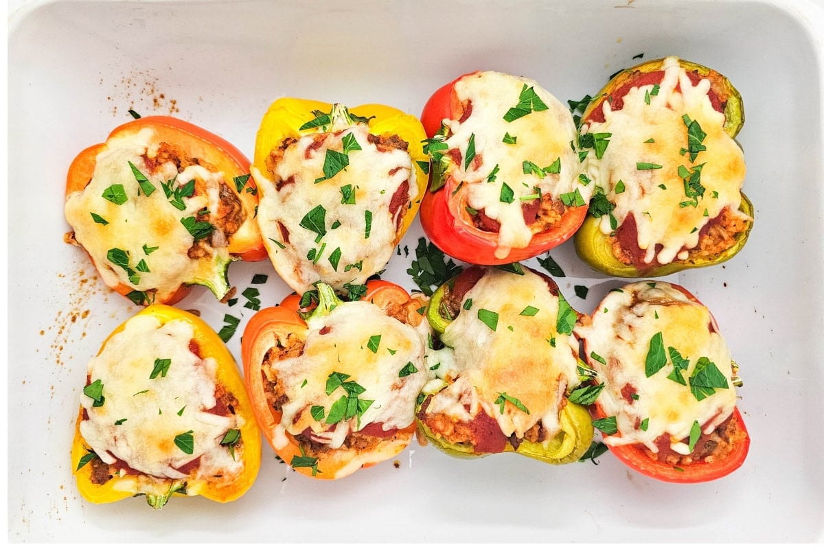 Stuffed bell peppers arranged in a baking dish.