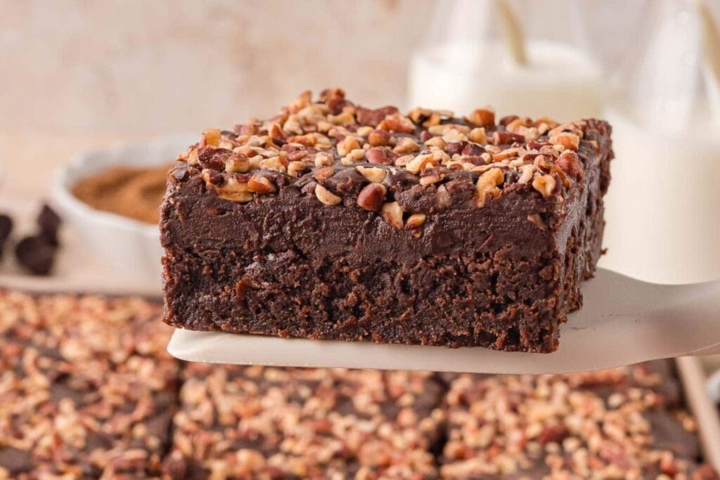 German chocolate brownies with pecan topping on a spatula.