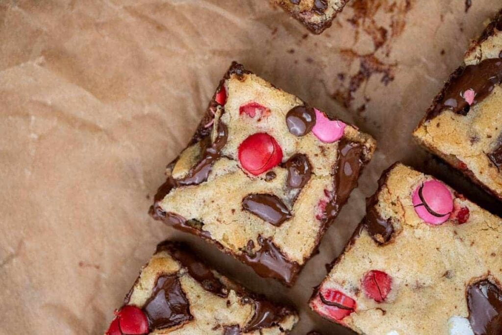 alentine’s Day M&M blondies on parchment paper.
