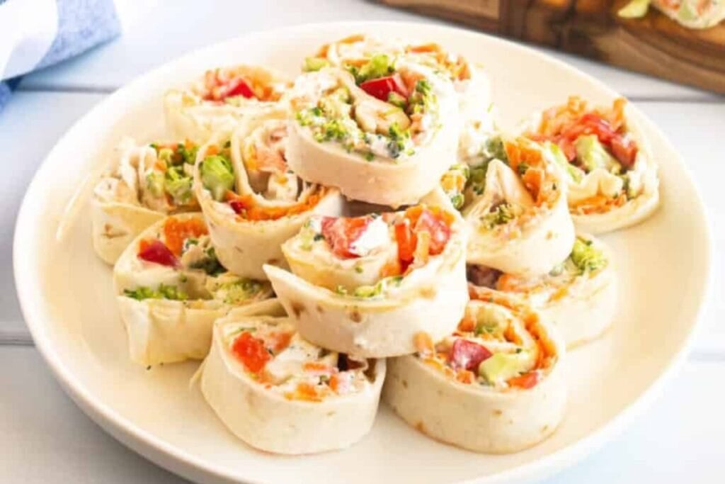 Veggie pinwheels with cream cheese on a plate.