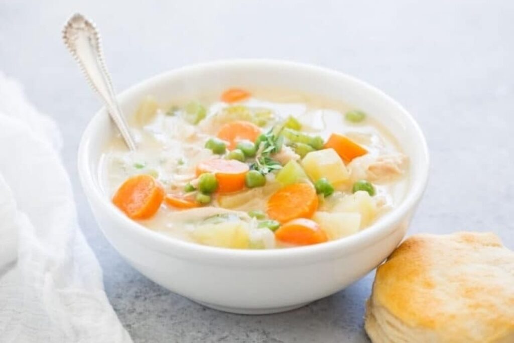 A close up shot of chicken pot pie soup.