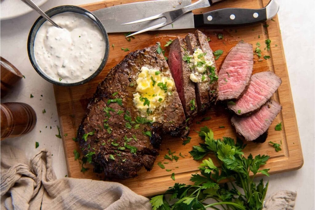 Air fryer London broil on a wooden cutting board.