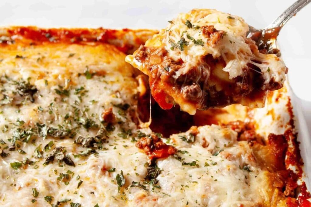 Baked ravioli casserole topped with melted cheese in a baking dish.