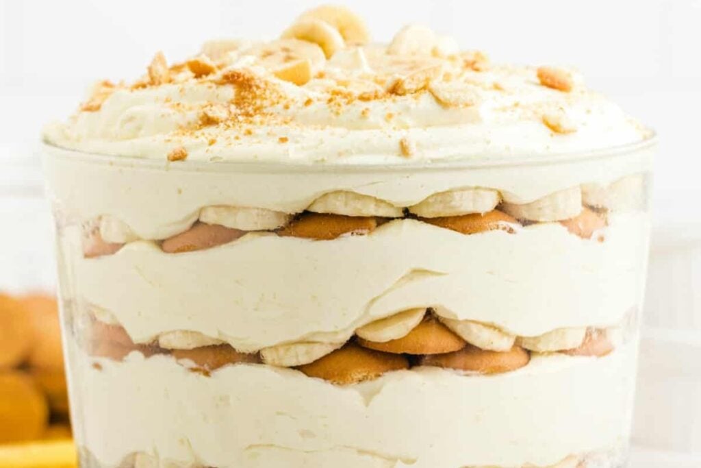 Banana pudding layered in a clear glass.