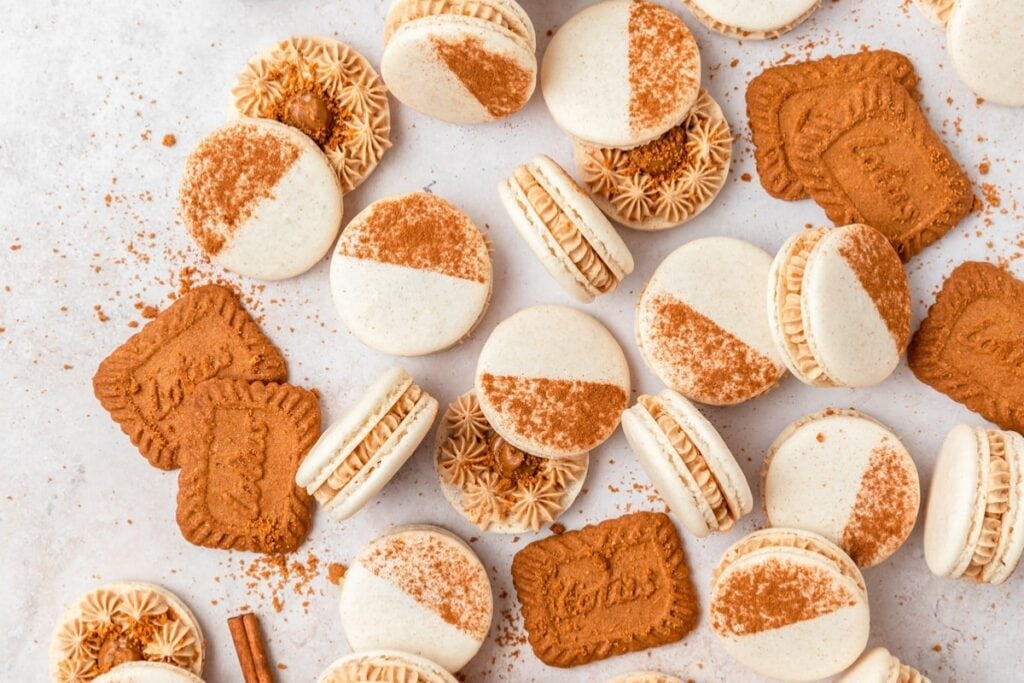 Biscoff cookie butter macarons on a parchment paper.