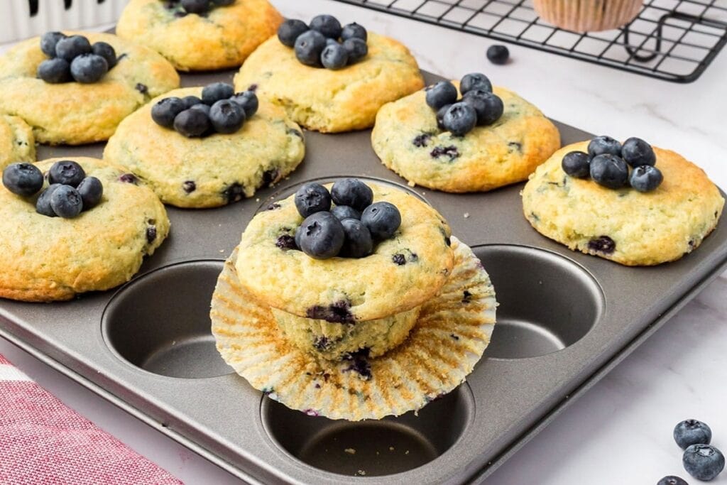 Blueberry pancake mix muffins cooling on a baking tray.