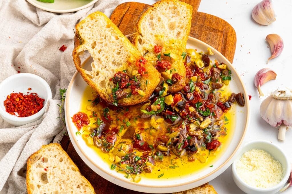 Bread dipping oil in a bowl.
