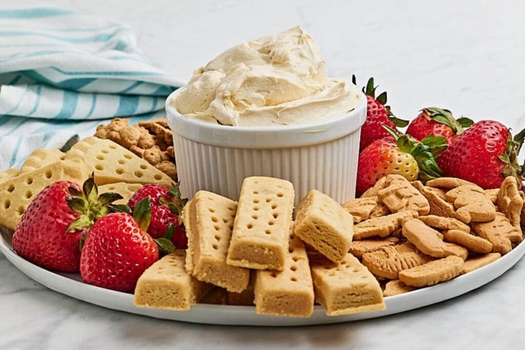 Cheesecake dip in a white ramekin served on a platter.