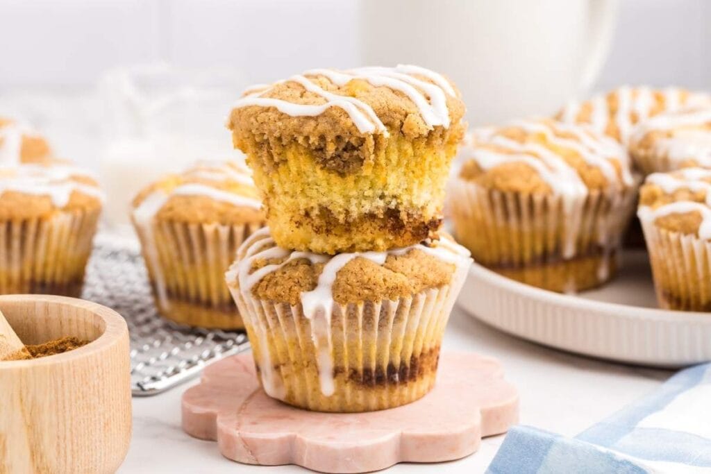 Coffee cake muffins stacked on a marble coaster.