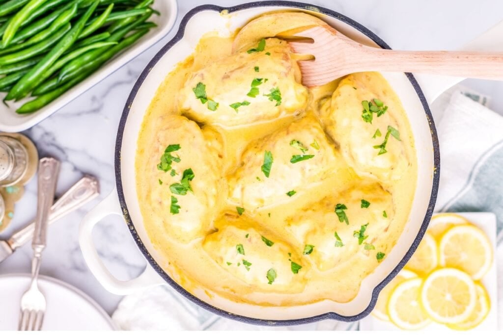 Creamy lemon chicken in a pot.