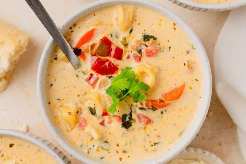 Creamy sausage and tortellini soup in a bowl.
