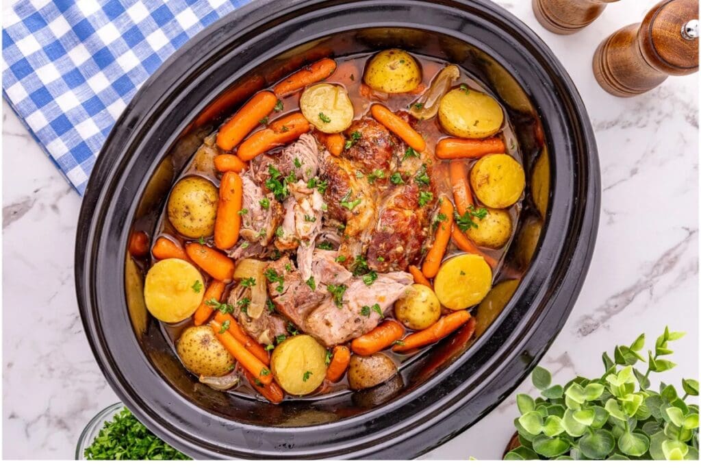 Pork roast with vegetables in a crockpot.
