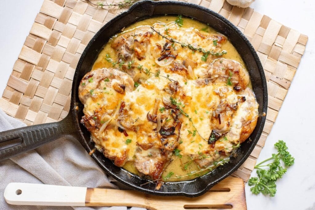 French onion pork chops in a skillet.