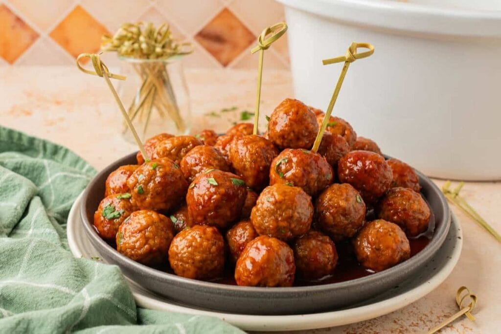 Grape jelly meatballs on a plate.