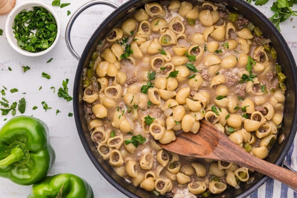 Philly cheesesteak pasta in a skillet.