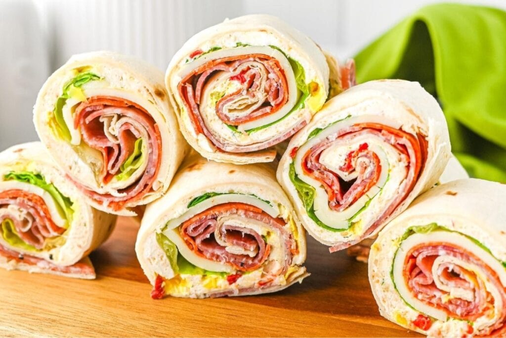 Italian pinwheels on a wooden board.
