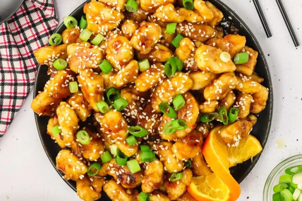 Orange glazed chicken on a plate.