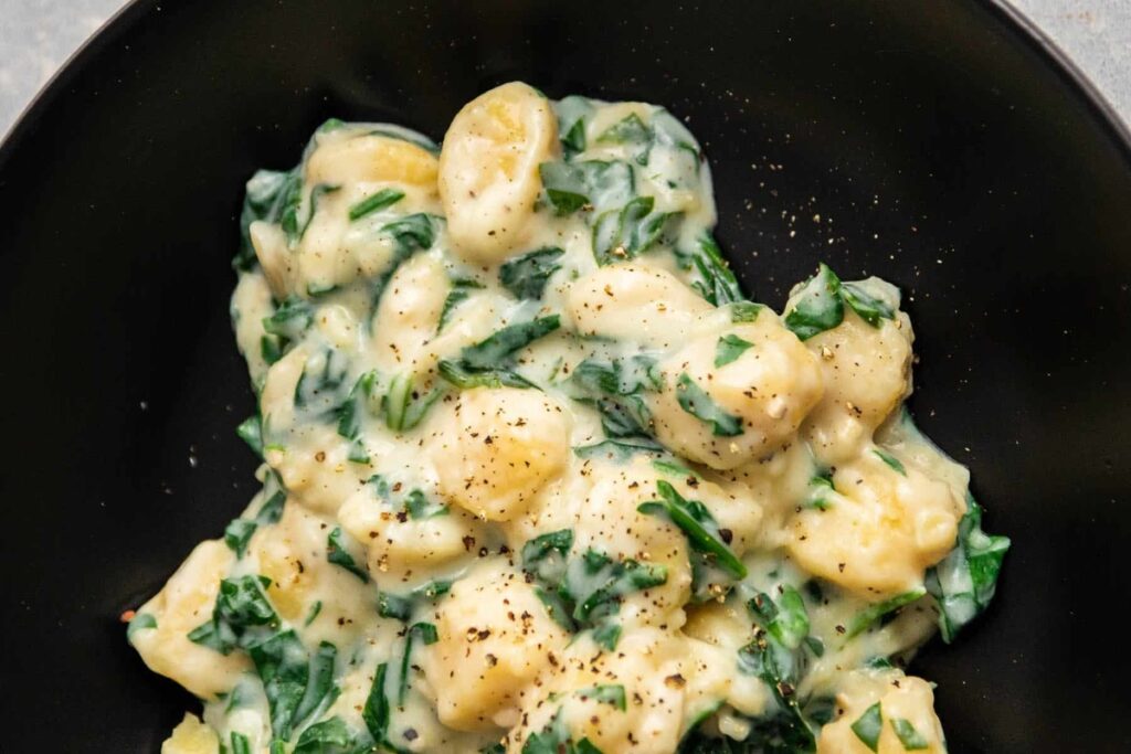 Parmesan spinach gnocchi on a plate.