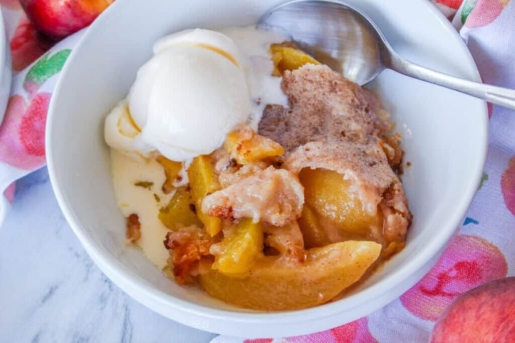 Peach cobbler in a bowl.