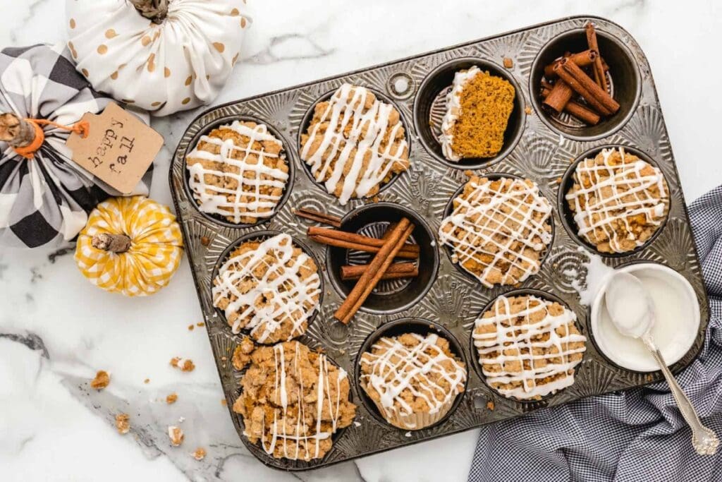 Pumpkin streusel muffins on a baking tray.