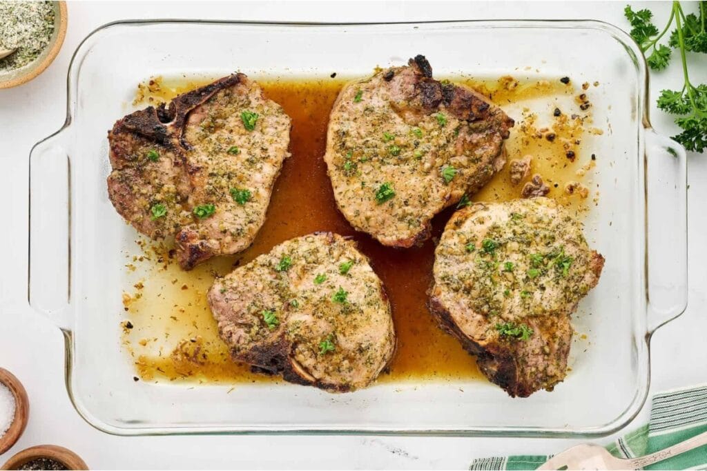 Ranch oven baked pork chops in a glass baking dish.