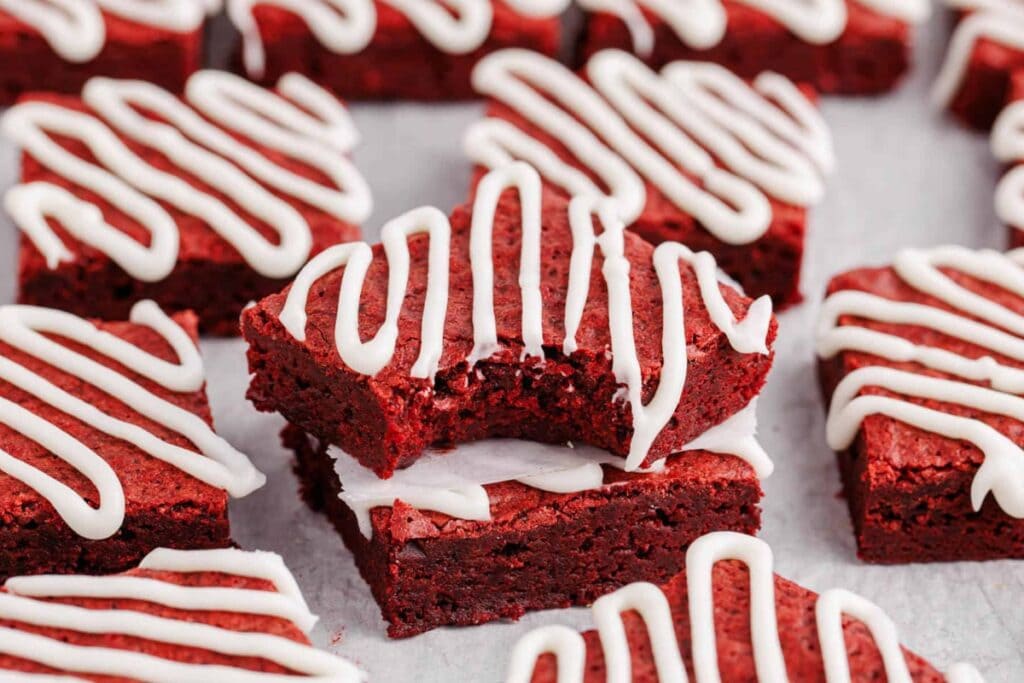 Red Velvet brownie squares on parchment paper.