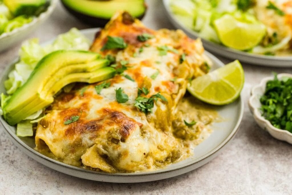 Salsa verde chicken enchiladas on a plate.