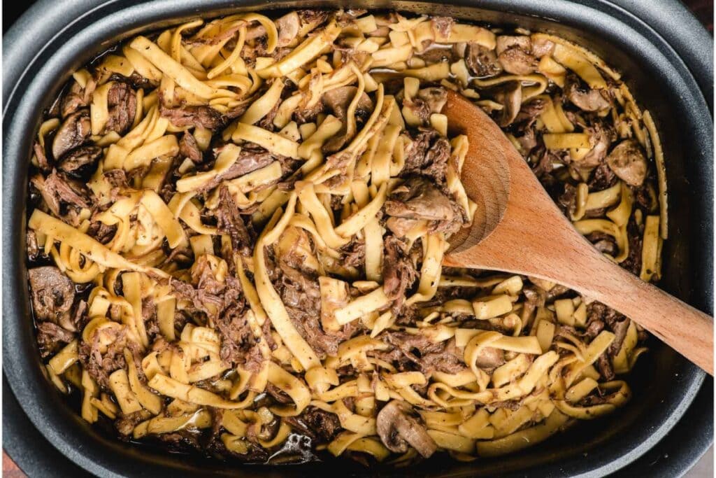 Beef and noodles in a slow cooker.