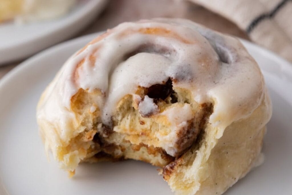 Single cinnamon roll on a plate.