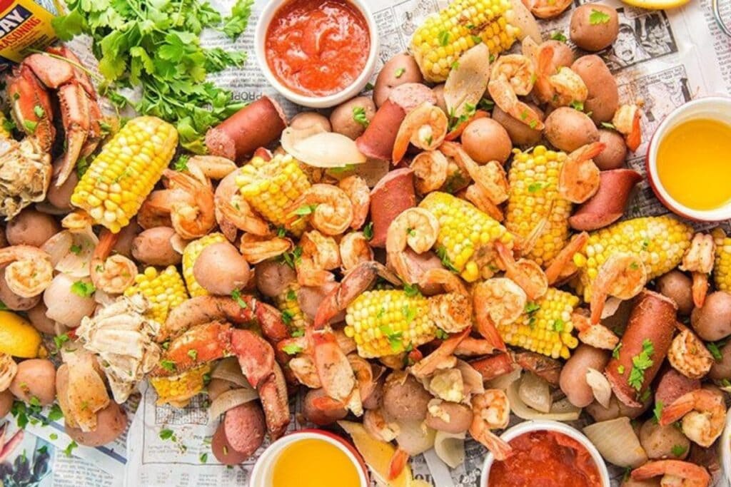 Top view of a southern low country boil with shrimp, corn, potatoes, sausage, and crab.