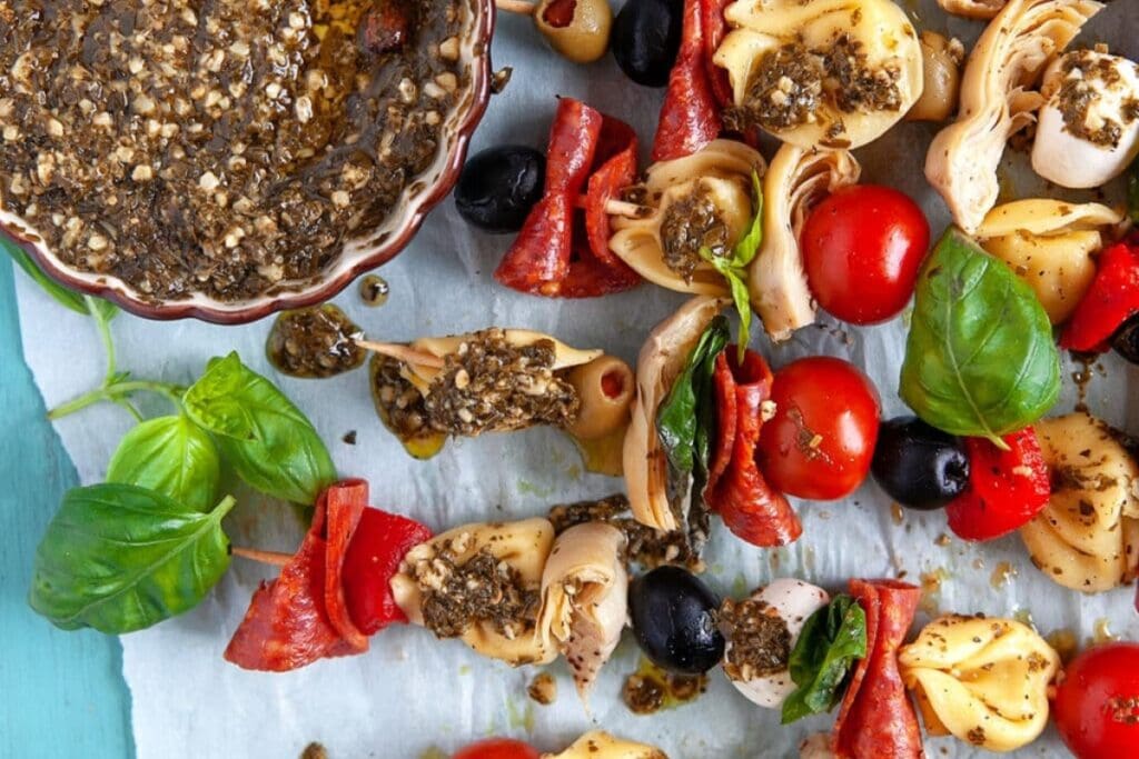 Tortellini skewers on parchment paper.