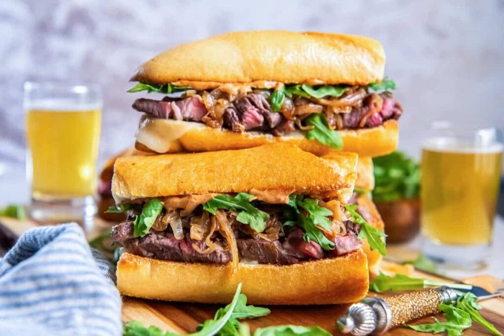 Ultimate steak sandwich on a wooden board.