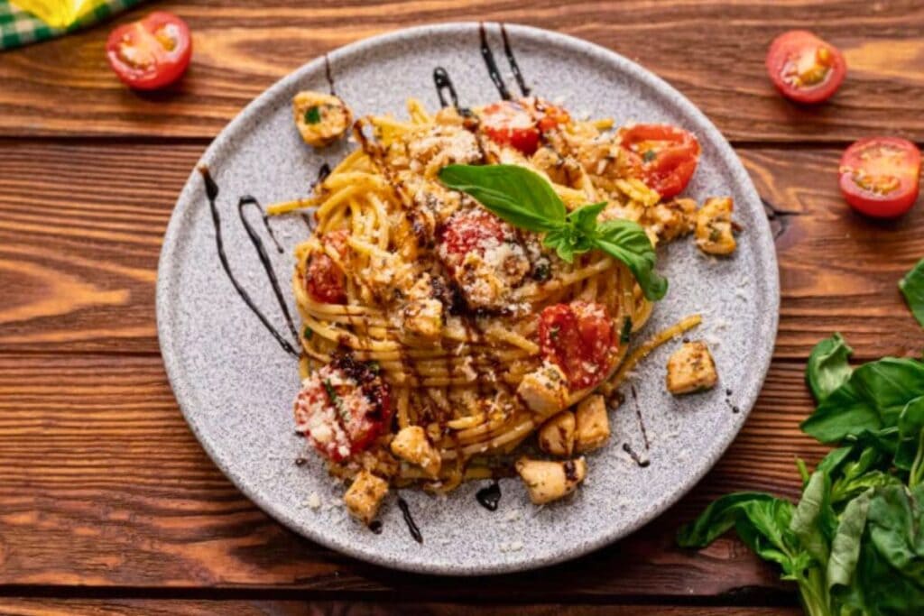 A close up shot of bruschetta chicken pasta.