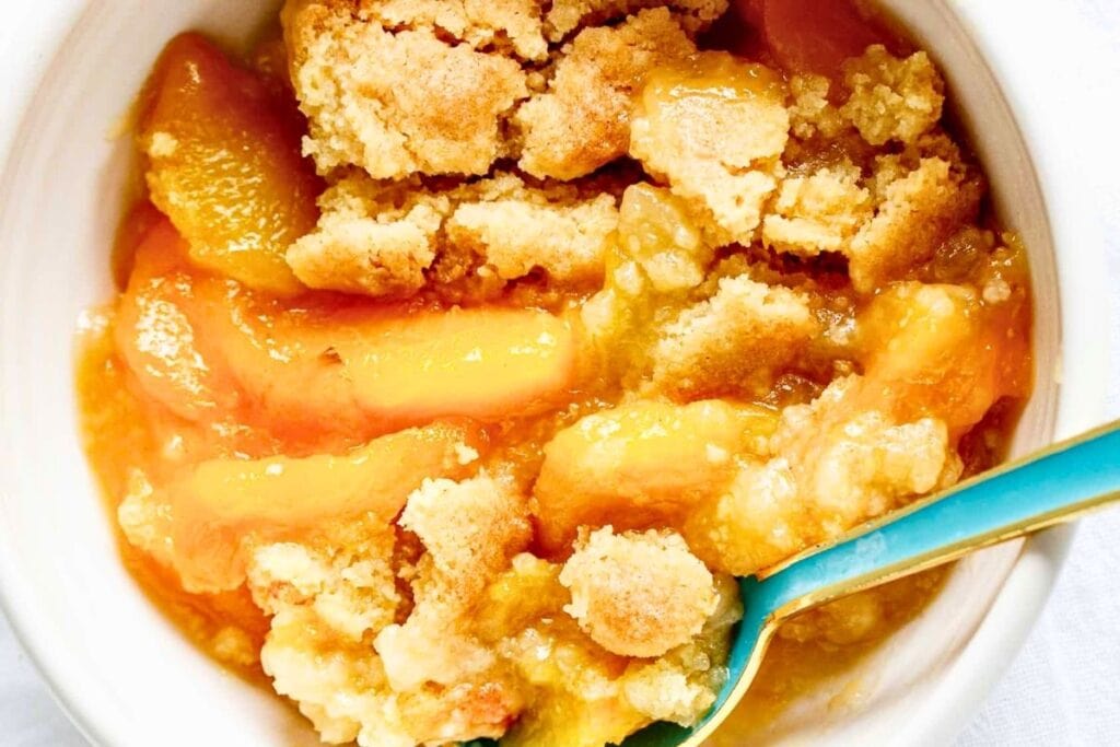 A close up shot of peach dump cake.