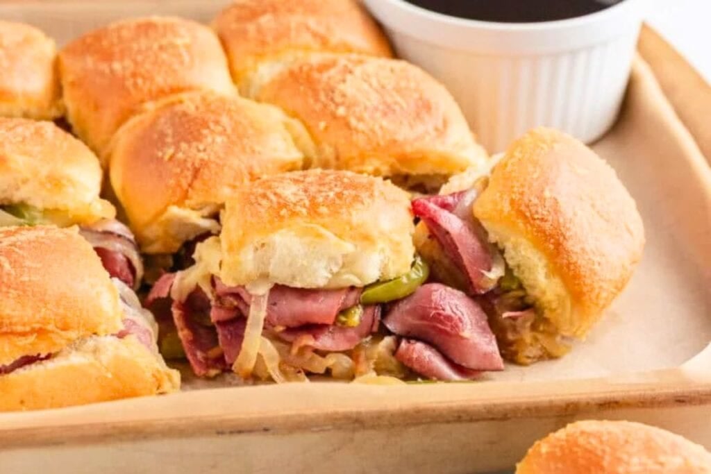 A close up shot of cheesesteak sliders.