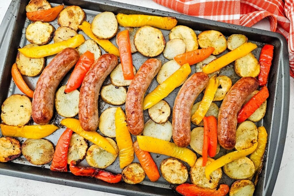 A close up shot of sheet pan sausage peppers and potatoes.