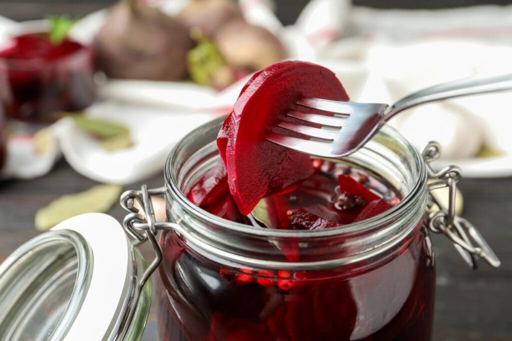 Sliced beets in a glass jar.